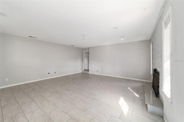 9951 NE 30th Ct, Anthony, FL 32617 - unfurnished living room featuring baseboards, visible vents, and a brick fireplace