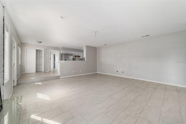 9951 NE 30th Ct, Anthony, FL 32617 - empty room featuring a textured ceiling, baseboards, and visible vents