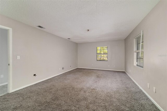 9951 NE 30th Ct, Anthony, FL 32617 - carpeted spare room featuring baseboards, a textured ceiling, and visible vents