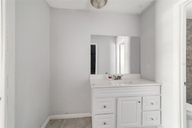 9951 NE 30th Ct, Anthony, FL 32617 - bathroom featuring toilet, vanity, and baseboards