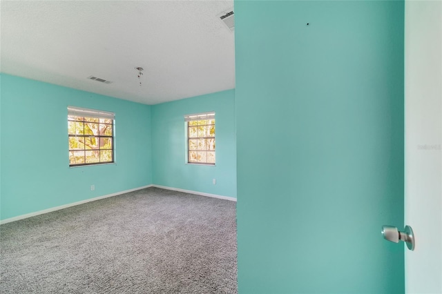 9951 NE 30th Ct, Anthony, FL 32617 - unfurnished room featuring baseboards, visible vents, and carpet