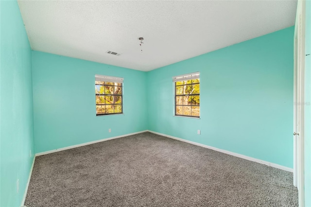 9951 NE 30th Ct, Anthony, FL 32617 - carpeted empty room with a textured ceiling, baseboards, and visible vents