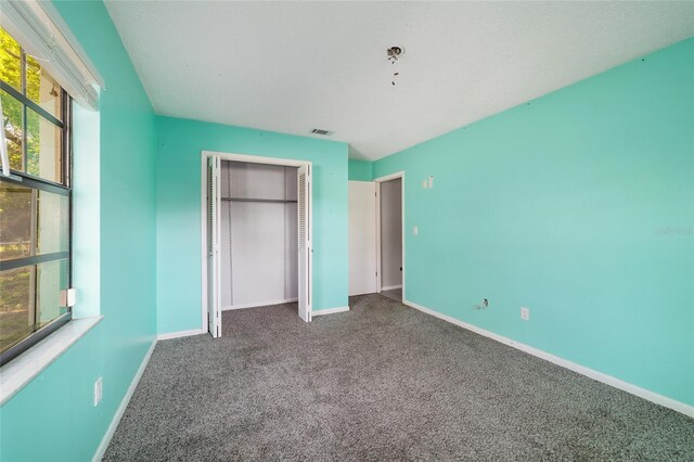 9951 NE 30th Ct, Anthony, FL 32617 - unfurnished bedroom featuring baseboards, visible vents, a closet, and carpet floors