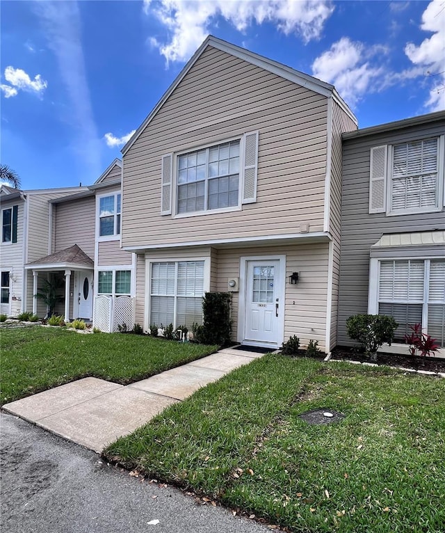 view of property featuring a front lawn