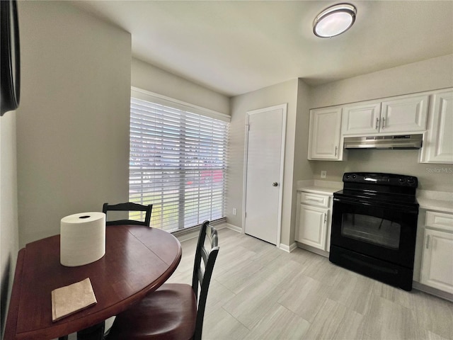 kitchen featuring under cabinet range hood, white cabinets, light countertops, and black range with electric stovetop