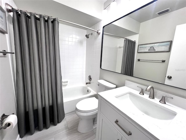 full bath with vanity, toilet, visible vents, and shower / tub combo with curtain