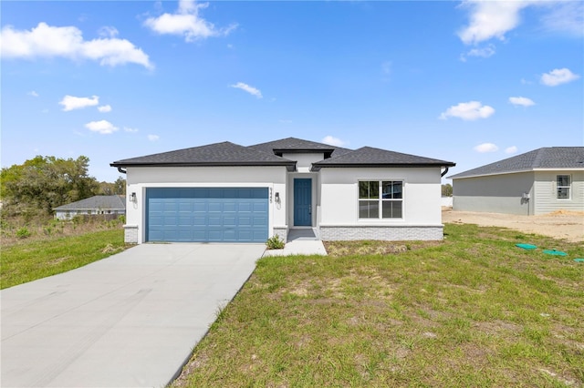 prairie-style home with driveway, stucco siding, a front yard, and a garage