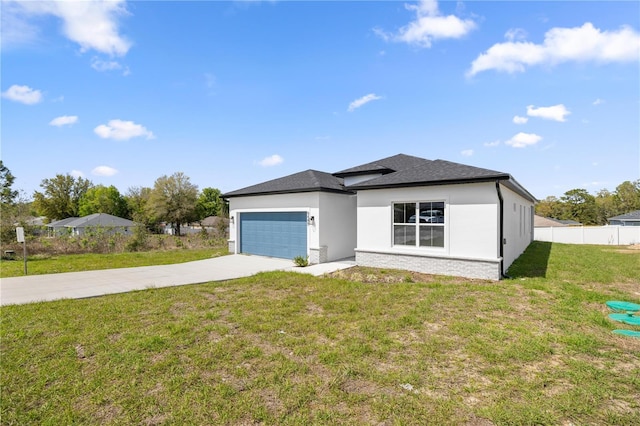 view of front of house featuring driveway, fence, an attached garage, a front lawn, and stucco siding
