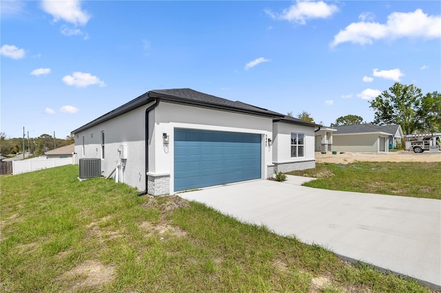 view of property exterior featuring stucco siding, an attached garage, driveway, central AC, and a lawn