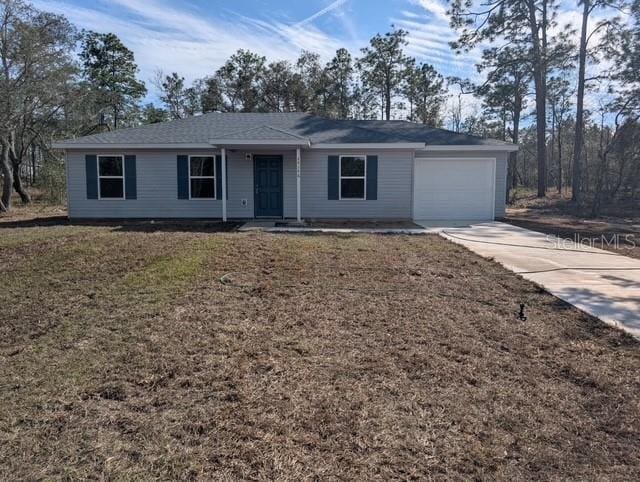 ranch-style house with a front yard, an attached garage, and driveway