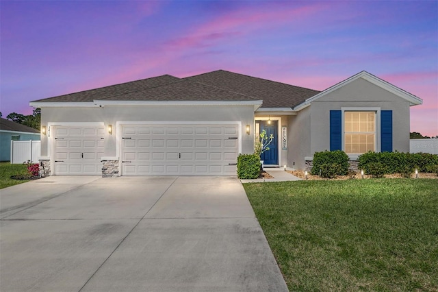 single story home with an attached garage, a shingled roof, stucco siding, concrete driveway, and a lawn