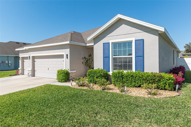 ranch-style home featuring stucco siding, an attached garage, driveway, and a front yard