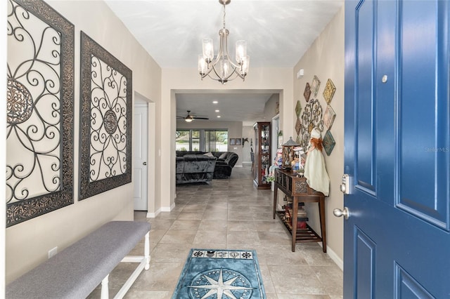 entrance foyer featuring a notable chandelier, baseboards, and light tile patterned floors