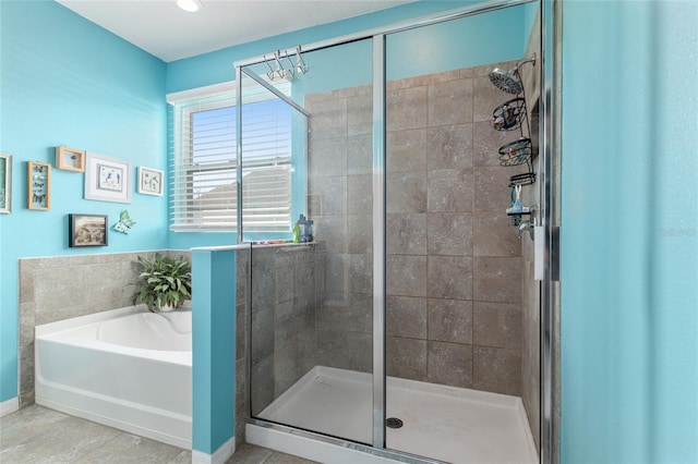 bathroom with a bath and a shower stall