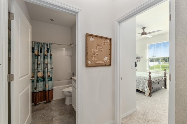 bathroom with ceiling fan, ensuite bathroom, tile patterned floors, toilet, and shower / tub combo with curtain