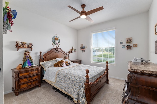 bedroom with light carpet, baseboards, and ceiling fan