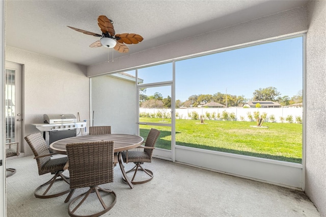 sunroom featuring a ceiling fan