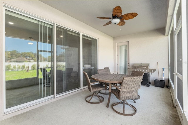 sunroom / solarium featuring ceiling fan