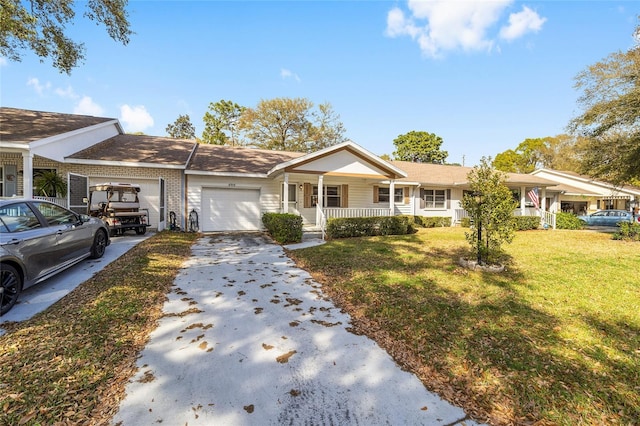 view of front of house featuring a front yard, a porch, concrete driveway, and an attached garage