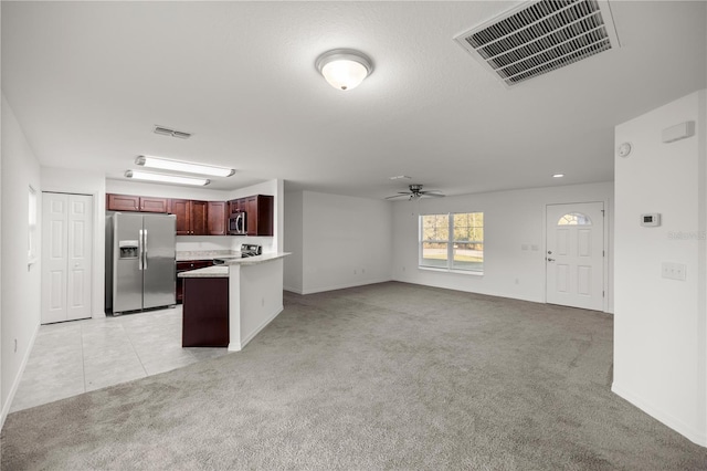 kitchen with visible vents, light colored carpet, and appliances with stainless steel finishes