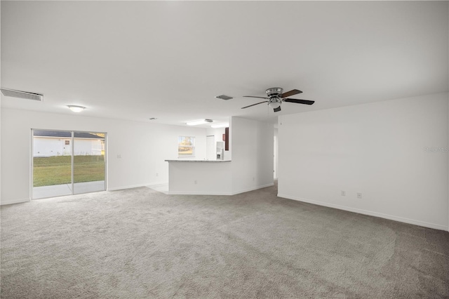 unfurnished living room with visible vents, baseboards, a ceiling fan, and carpet flooring