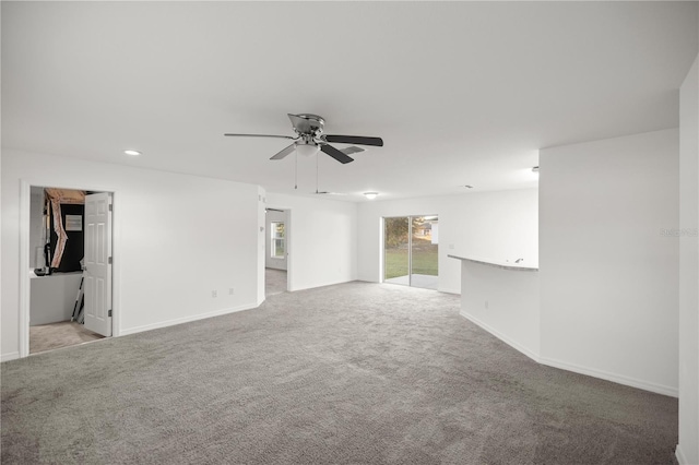 spare room with recessed lighting, baseboards, light carpet, and ceiling fan