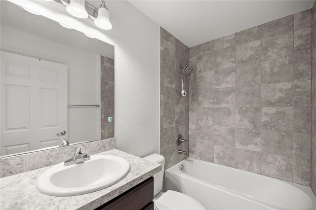 full bath with shower / bath combination, toilet, vanity, and a textured wall