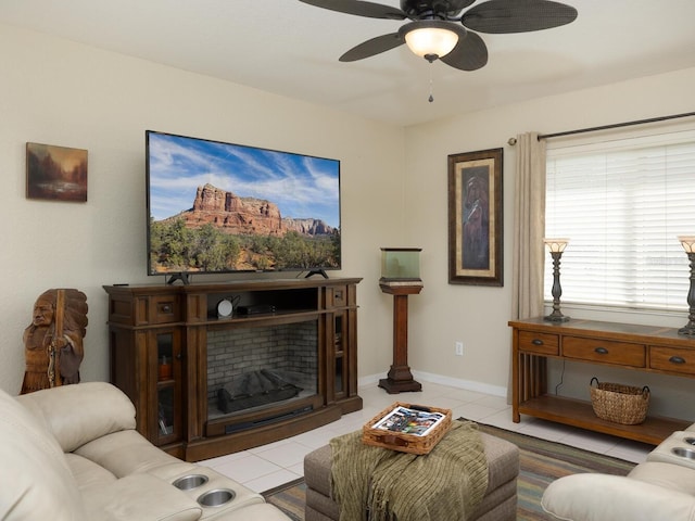 living room featuring baseboards, light tile patterned flooring, and a ceiling fan