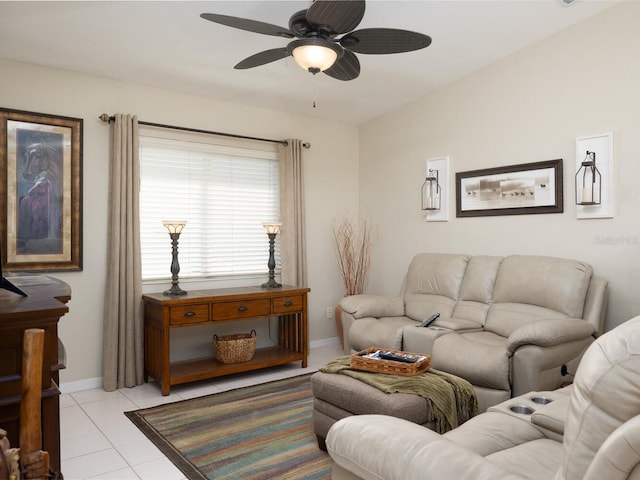 living area featuring light tile patterned flooring, a ceiling fan, and baseboards