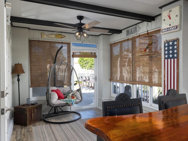 interior space featuring beamed ceiling, wood finished floors, and ceiling fan