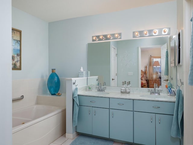 full bath with a sink, ensuite bath, double vanity, and a bath