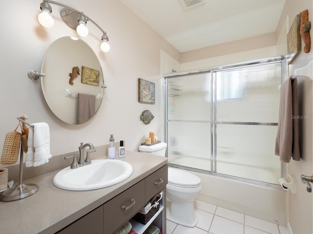 bathroom with vanity, visible vents, enclosed tub / shower combo, tile patterned flooring, and toilet