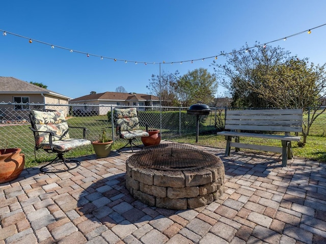 view of patio featuring fence and a fire pit