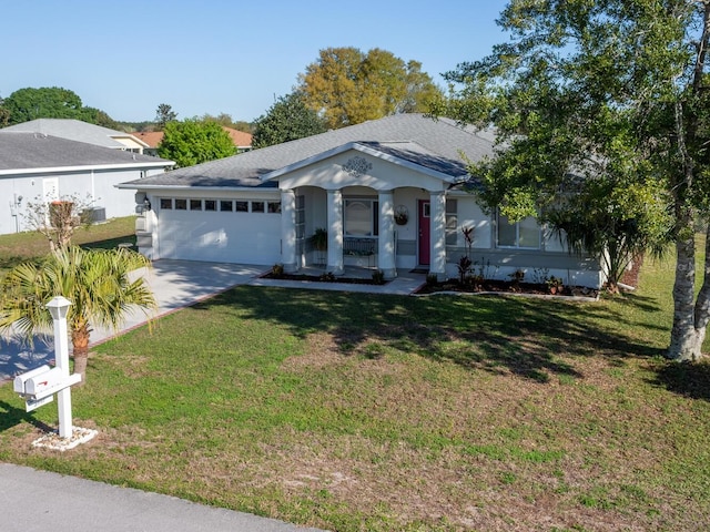 single story home featuring an attached garage, driveway, a front yard, and roof with shingles