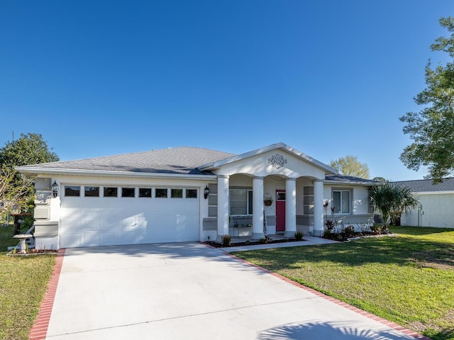 view of front of house with stucco siding, concrete driveway, a garage, and a front yard