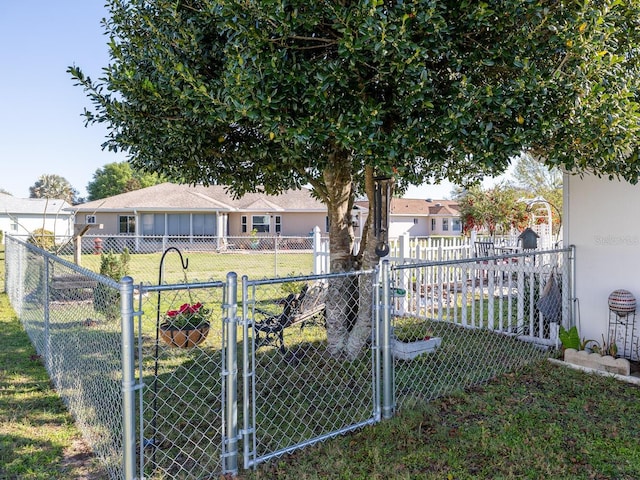 view of yard featuring fence and a gate