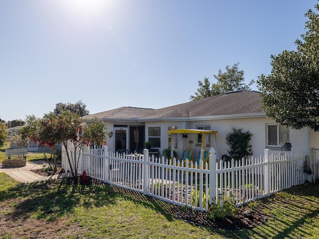 ranch-style house featuring a fenced front yard, a front yard, and stucco siding