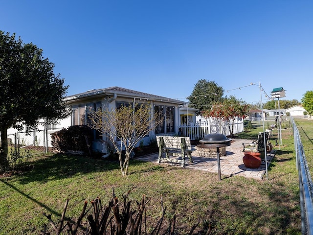 view of yard with a fire pit, a patio, and fence