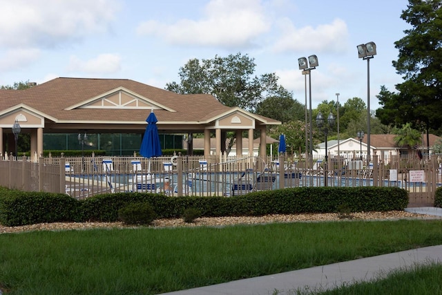 view of community with a pool and fence