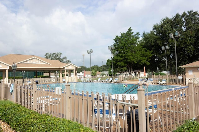 community pool featuring a patio area and fence