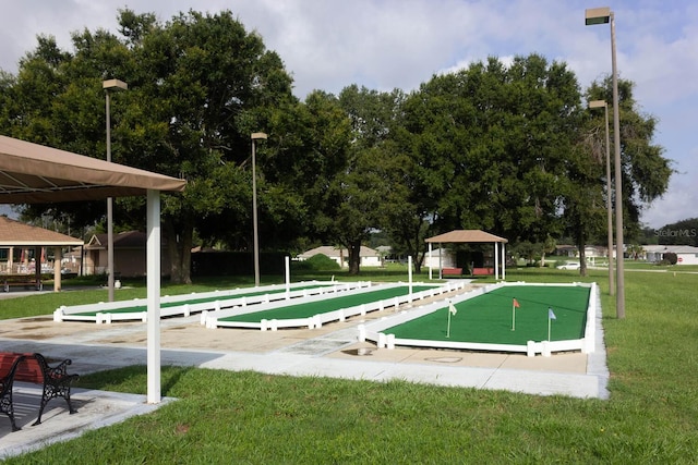 view of property's community with a lawn