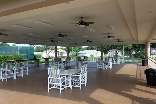 view of patio with outdoor dining space and fence