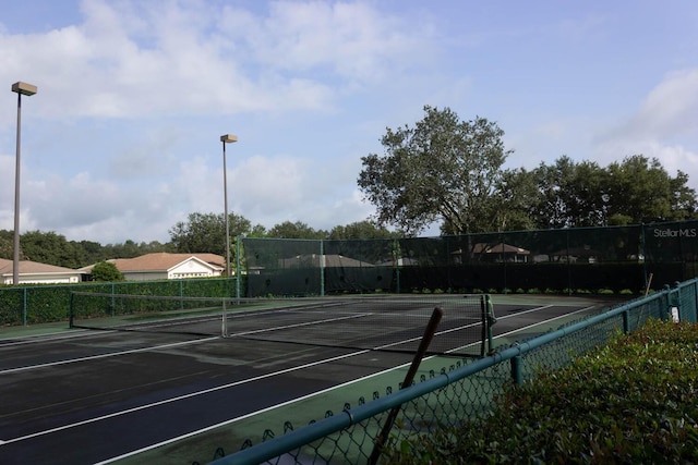 view of sport court with fence