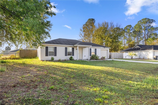 ranch-style house featuring a front yard, fence, a garage, and driveway