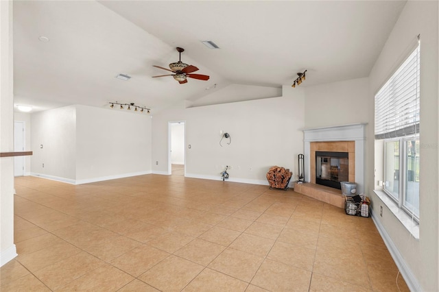 unfurnished living room with visible vents, a ceiling fan, light tile patterned flooring, baseboards, and a tile fireplace