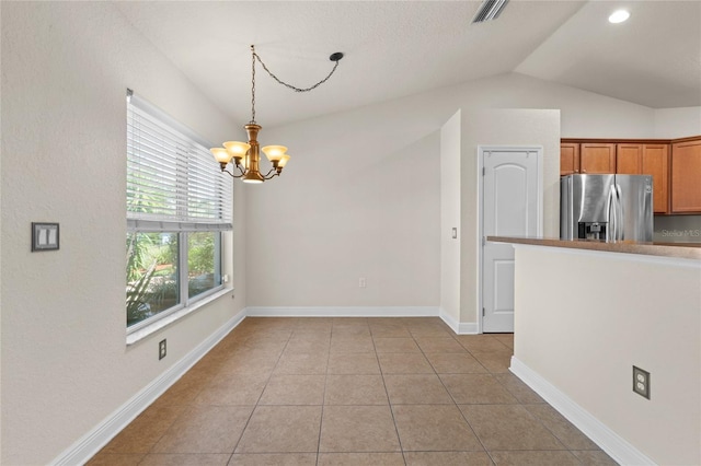 unfurnished dining area featuring a notable chandelier, visible vents, lofted ceiling, and light tile patterned floors