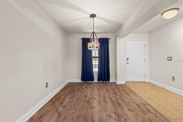 interior space featuring baseboards and wood finished floors