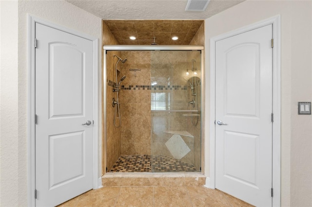 full bathroom featuring visible vents and a stall shower