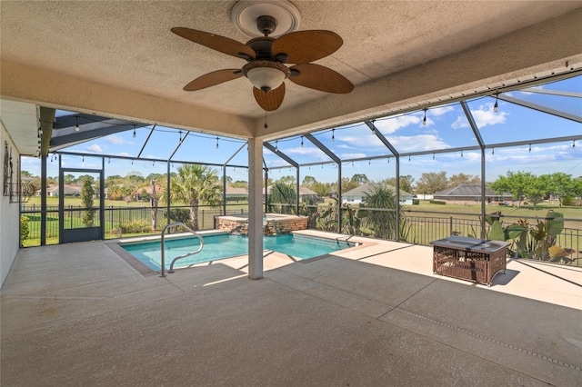 view of pool featuring glass enclosure, a patio area, and a pool with connected hot tub