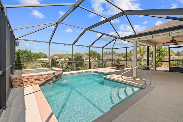 view of swimming pool with glass enclosure, a patio, ceiling fan, and a pool with connected hot tub